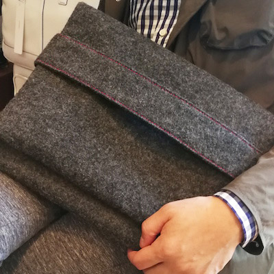 are brand world Clutch Case grey on mans lap
